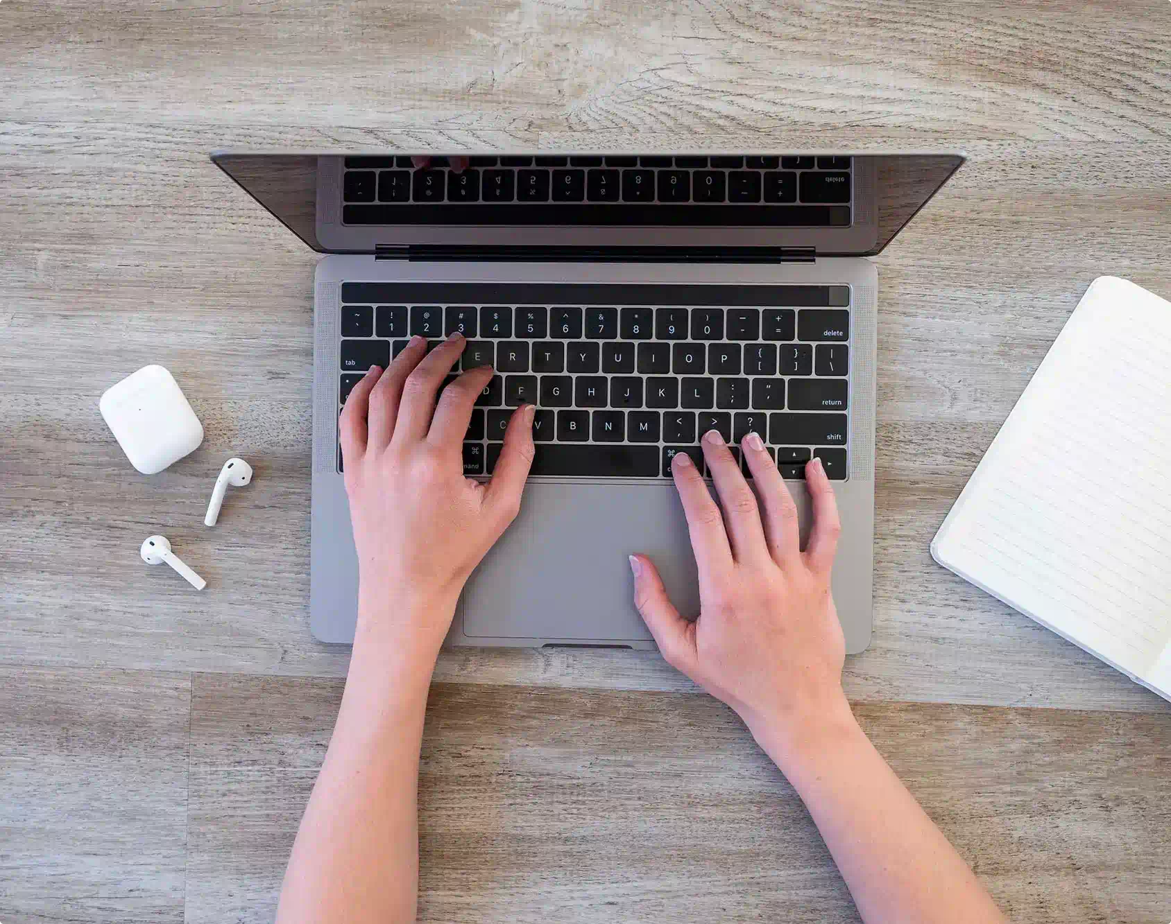 Person holding hands on laptop keyboard